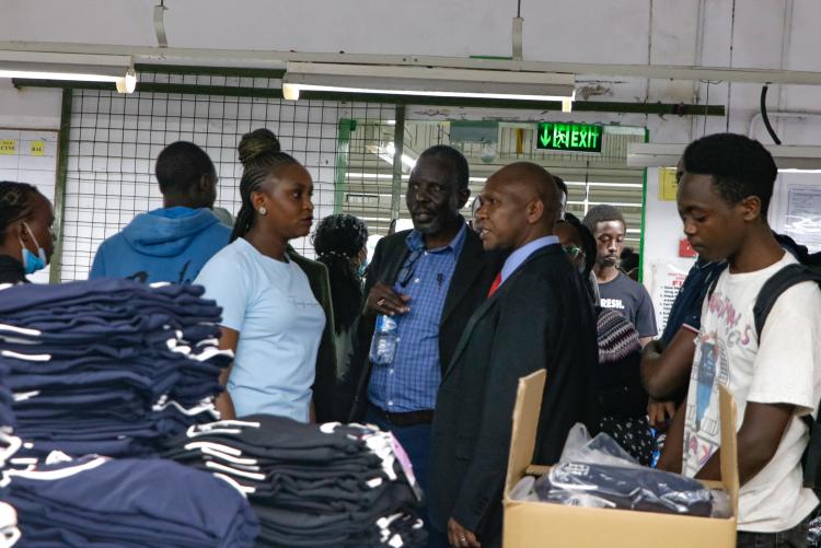 Topnew Knitwear CEO's Assistant,  Ms. Christine Musyoki taking CIUoN students on the garment making tour.